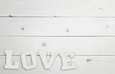 White wooden background with big love sign 