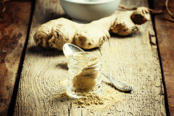 Ground ginger, old wooden background, selective focus