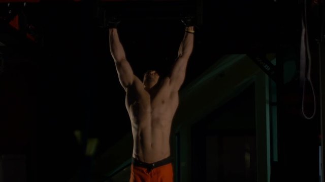 The man pulled on the bar at the gym