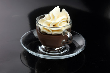 Hot chocolate cocoa with whipped cream on vintage wooden background, selective focus