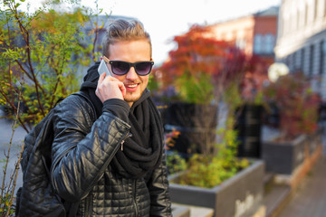 Handsome man talking on the phone and smiling