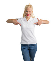 Woman in white polo T-shirt pointing at it with both hands