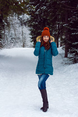 Fototapeta na wymiar Girl walking in winter forest