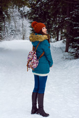 Girl walking in winter forest