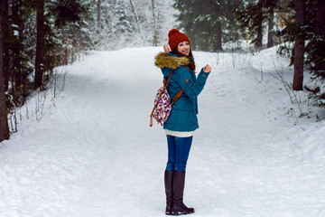Girl walking in winter forest