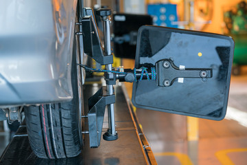 Closed up of an auto wheel : wheel alignment.
Balancing tire wheel machine. Tyre assembling. Tire balance - Car service