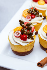 Delicious pumpkin cupcakes on white dish.