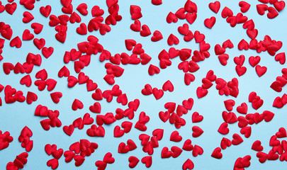 Texture of red little hearts on blue background