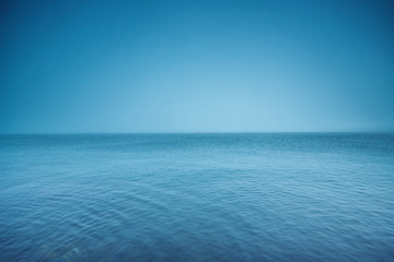 Cloudy horizon. Fog over the sea waves, natural background