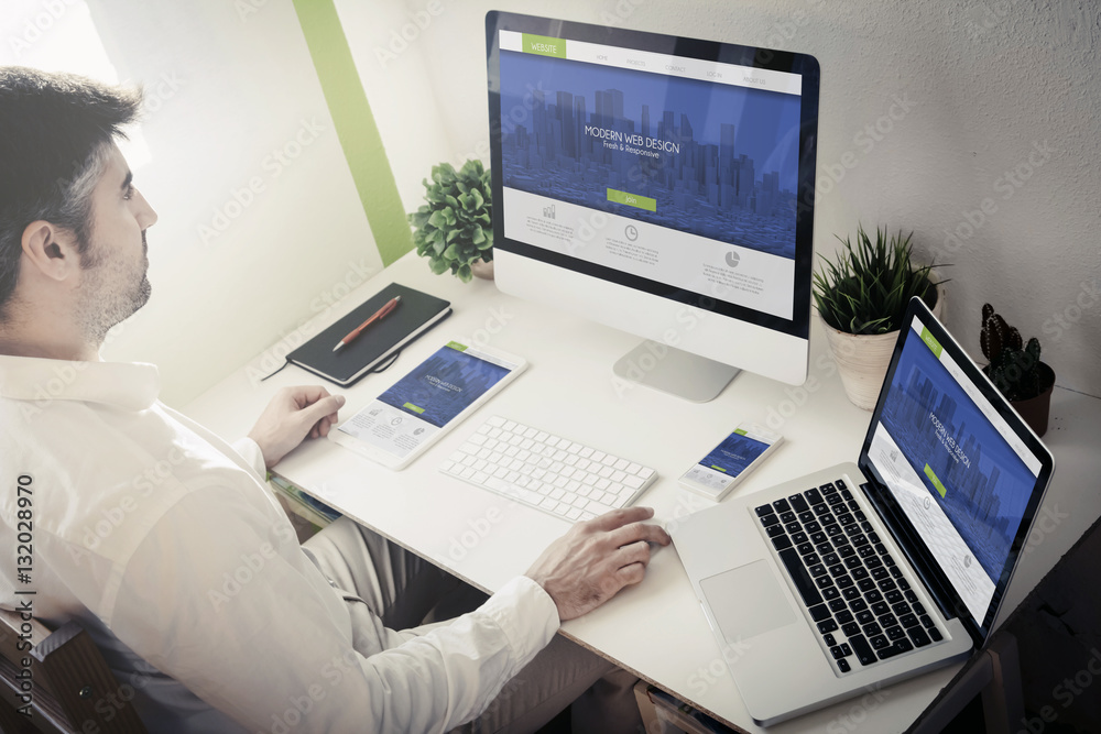 Wall mural man working with devices modern web design