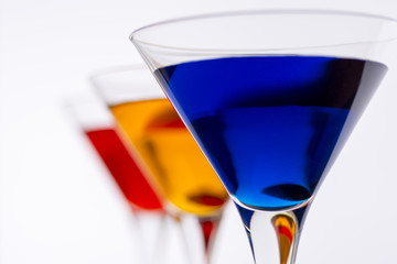 Colorful Cocktails in Martini Glasses Background. Bar Commercials Concept.