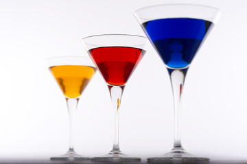 Colorful Cocktails in Martini Glasses Background. Bar Commercials Concept.