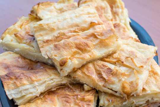 Traditional Serbian cheese pie gibanica closeup  in baking pan