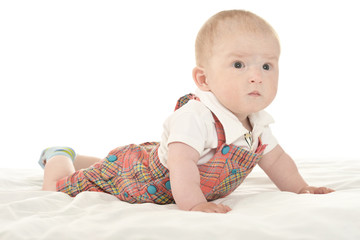 Baby boy crawling on blanket