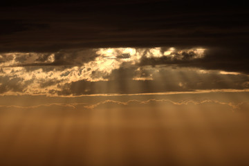 Beautiful sunset in winter, cloudy sky, sun ray in the sea of clouds