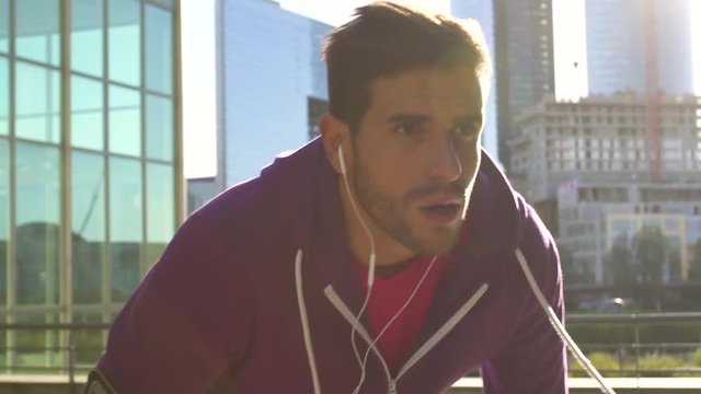 athlete with earphones running in the city, Slow motion, HD movie (1920X1080)