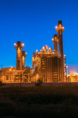 Fototapeta na wymiar Gas turbine electrical power plant at dusk In industrial estate with blue hour 