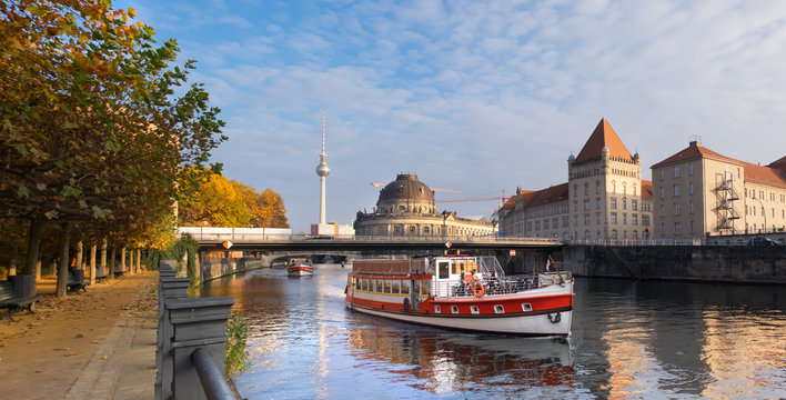 Berlin, Spree river in Autumn with touristic boat
