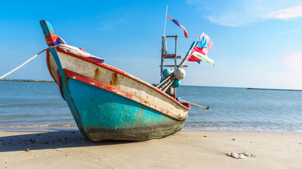 fishing boat on the beach with blue sky background in Thailand