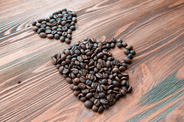 Coffee cup made from beans, grain with heart on wooden background. Valentine's Day or Wedding, love, black, frame. shaped . in shape of