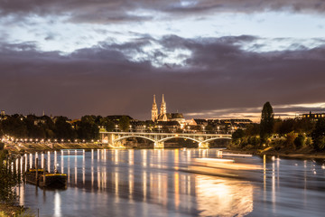 Fototapeta na wymiar Night view of Rhine River with Basel Minster