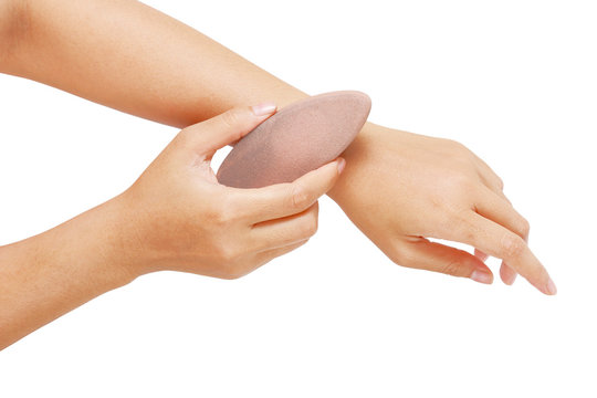 hand with grey soft spa stone isolated with clipping path