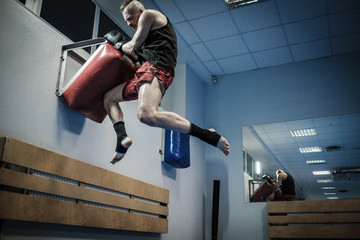 Fighter training with punching pad at gym © Nejron Photo