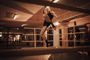 Fototapeta na wymiar Fighter shadowboxing on training ring