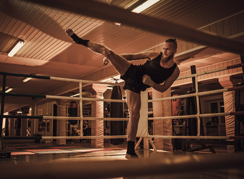 Fighter shadowboxing on training ring