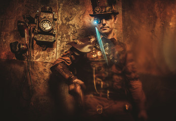 Portrait of steampunk man with various mechanical devices on vintage steampunk background