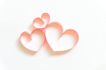 Valentines day card - heart made of ribbon on white background.