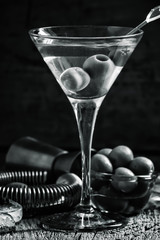 Black and white photo. Dry martini, vermouth with olives