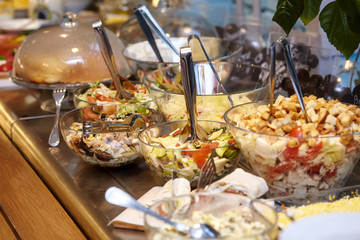 Fototapeta na wymiar Bowls with various food in self service restaurant