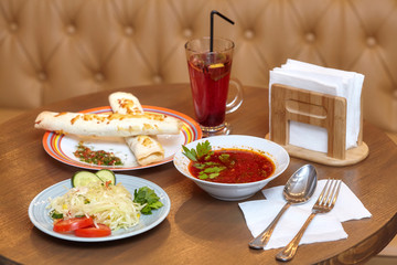 Lunch set with shaurma, red soup and salad, served food