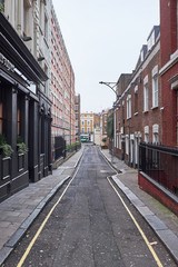A look down Conduit Place, a narrow alley with highrise and low residential buildings