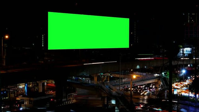 Advertising Billboard with green screen and traffic at night, for advertisement, time lapse.