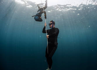 Free diver performing warm up dive - static apnea on the depth