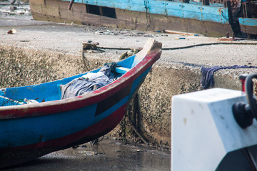 Fototapeta na wymiar Broken abandoned fishing boat by the shore