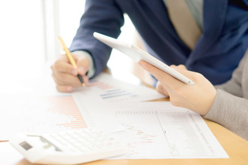 Young businesswoman explaining report to her colleague at meetin