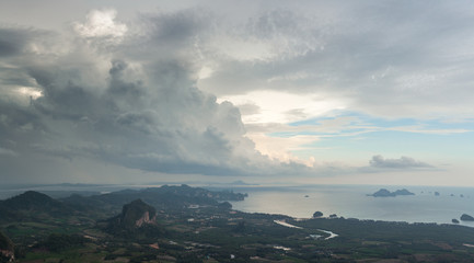 Panorama of the valley with limestone mountains and dark sky with clouds
