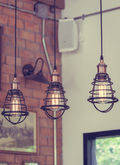 Vintage metal cap lamp hanging from the ceiling in a vertical picture. (vintage style)