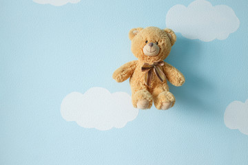 Teddy bear hanging on the wall.