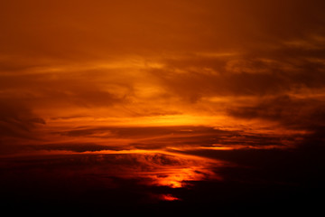 Fototapeta na wymiar sunset in winter, cloudy sky, sun ray in the sea of clouds