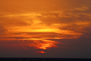 Magical beautiful sunset in winter, cloudy sky, sun ray in the sea of clouds