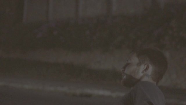 Young woman defends herself against male attacker on the street at night by elbowing him in the jaw - video in slow motion