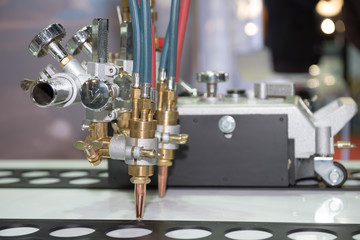 Technology of making laser incisions on furniture workshop. laser beam cutter machine cutting metal sheet. Close up