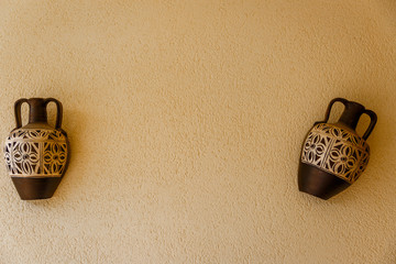 Two amphoras decorating the wall of a patio