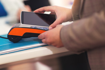 Woman using mobile phone to pay