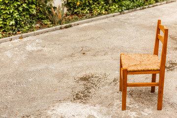 Fototapeta na wymiar A wooden and wicker chair in a cozy patio