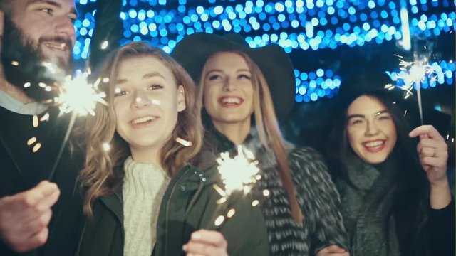 Picture showing group of friends having fun with sparklers